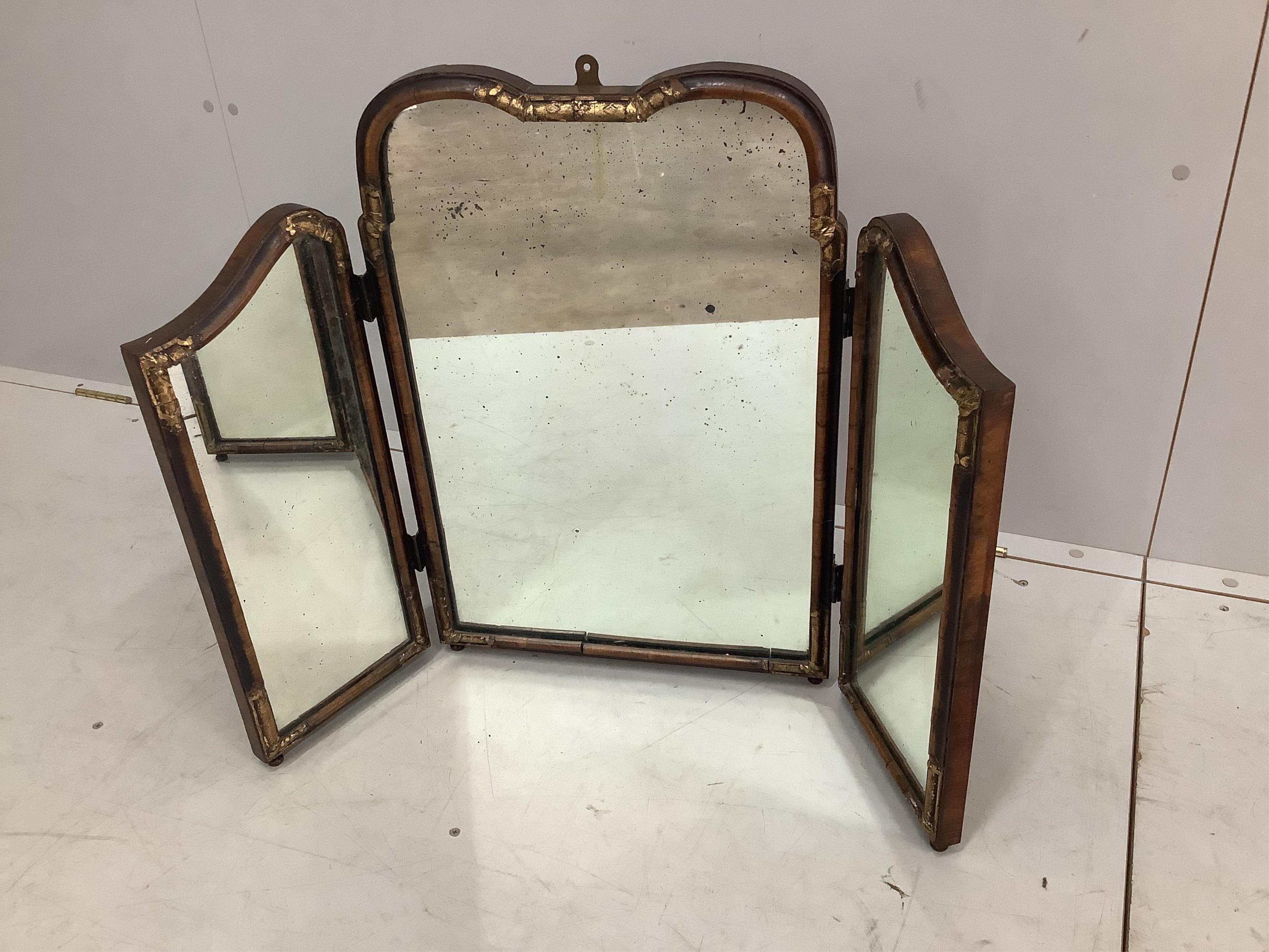 A Queen Anne Revival parcel-gilt walnut folding triptych dressing table mirror, height 64cm. Condition - fair